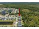 Aerial view showing position of house relative to the street, nearby houses and wooded area at 13013 Satin Lily Dr, Riverview, FL 33579