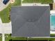 Aerial view of dark grey shingled roof and backyard pool surrounded by white concrete at 13013 Satin Lily Dr, Riverview, FL 33579