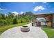 Backyard featuring a cozy fire pit and an outdoor kitchen for entertainment at 13013 Satin Lily Dr, Riverview, FL 33579