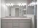 Bathroom featuring double vanity and frameless glass shower at 13013 Satin Lily Dr, Riverview, FL 33579