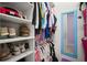 Organized closet with clothes, shoes, and personal items neatly arranged on shelves and hanging rods at 13013 Satin Lily Dr, Riverview, FL 33579