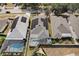 Birds eye view of a well-maintained home with solar panels, screened pool, and lush landscaping at 1333 Dragon Head Dr, Valrico, FL 33594