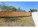 The spacious backyard offers privacy with a wooden fence, and space for outdoor activities at 1333 Dragon Head Dr, Valrico, FL 33594