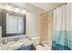Bathroom featuring a granite vanity top, decorative mirror, and a tub with an artistic shower curtain at 1333 Dragon Head Dr, Valrico, FL 33594