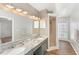 Bathroom featuring dual sinks, granite countertop, and glass door shower at 1333 Dragon Head Dr, Valrico, FL 33594