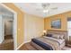 Cozy bedroom with a decorative paneled wall, complemented by warm paint colors and a ceiling fan at 1333 Dragon Head Dr, Valrico, FL 33594