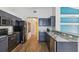 Sleek kitchen featuring granite countertops, stainless steel appliances, and stylish dark cabinetry at 1333 Dragon Head Dr, Valrico, FL 33594