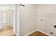 Unfurnished laundry room showcasing sleek laminate flooring and essential hookups at 1333 Dragon Head Dr, Valrico, FL 33594