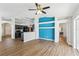 Open-concept living room with blue accent wall, hardwood floors, and modern fixtures at 1333 Dragon Head Dr, Valrico, FL 33594