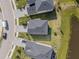 Overhead view of the house and surrounding neighborhood, featuring well-manicured lawns and nearby pond at 13981 Lilac Sky Ter, Bradenton, FL 34211