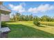 Scenic backyard with a tranquil pond view, providing a private and relaxing outdoor space at 13981 Lilac Sky Ter, Bradenton, FL 34211