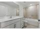 Well lit bathroom featuring white cabinets, quartz countertops, and tub-shower combo at 13981 Lilac Sky Ter, Bradenton, FL 34211