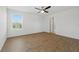 An empty bedroom is filled with natural light and finished with wood-look flooring at 13981 Lilac Sky Ter, Bradenton, FL 34211