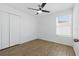 Bedroom with a ceiling fan, wood floors, a double door closet, and natural lighting at 13981 Lilac Sky Ter, Bradenton, FL 34211