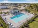 Stunning community pool with lounge chairs and a shaded pavilion, perfect for relaxation and recreation at 13981 Lilac Sky Ter, Bradenton, FL 34211
