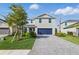 Beautiful two-story home featuring a blue garage door, a grey paver driveway, and a well-kept lawn at 13981 Lilac Sky Ter, Bradenton, FL 34211
