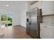 Kitchen with stainless steel refrigerator and a sliding glass door to the backyard at 13981 Lilac Sky Ter, Bradenton, FL 34211