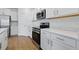 Updated kitchen with stainless steel appliances, sleek cabinets, and wood-look flooring at 13981 Lilac Sky Ter, Bradenton, FL 34211