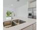 Close-up on stainless steel sink in the kitchen with white countertop at 13981 Lilac Sky Ter, Bradenton, FL 34211