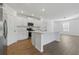 Bright kitchen featuring white cabinets, stainless steel appliances, and a large island with counter seating at 13981 Lilac Sky Ter, Bradenton, FL 34211
