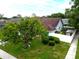 Aerial view of home with mature trees, manicured lawn, and updated roof at 1424 Ridge Shore Dr, Tarpon Springs, FL 34689
