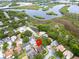 Drone view of property, surrounded by small ponds, marsh land and lovely neighborhood at 1424 Ridge Shore Dr, Tarpon Springs, FL 34689