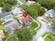 Overhead view of the home nestled in a desirable neighborhood with mature trees and manicured lawns at 1424 Ridge Shore Dr, Tarpon Springs, FL 34689