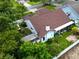 Aerial view of the home with a large backyard, mature trees, and white fence at 1424 Ridge Shore Dr, Tarpon Springs, FL 34689