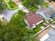 Aerial view of a charming home with a well-maintained, fenced backyard and lush surrounding trees at 1424 Ridge Shore Dr, Tarpon Springs, FL 34689
