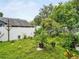 Lush backyard with a white fence, mature trees, and meticulously maintained landscaping at 1424 Ridge Shore Dr, Tarpon Springs, FL 34689