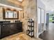 Luxurious bathroom featuring tiled walls, a double vanity, and access to a bedroom at 1424 Ridge Shore Dr, Tarpon Springs, FL 34689