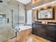 Luxurious bathroom with stone walls, glass shower, soaking tub, and double sink vanity at 1424 Ridge Shore Dr, Tarpon Springs, FL 34689