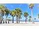 Beach scene featuring Palm trees, white sand, and a clear sky at 1424 Ridge Shore Dr, Tarpon Springs, FL 34689