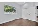 Bedroom featuring hardwood floors, large window, closet, and soft blue walls at 1424 Ridge Shore Dr, Tarpon Springs, FL 34689