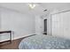 Bedroom featuring hardwood floors, closet, and a decorative ceiling fan at 1424 Ridge Shore Dr, Tarpon Springs, FL 34689