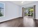Empty room with tile floors and sliding doors to an outdoor, screened-in patio at 1424 Ridge Shore Dr, Tarpon Springs, FL 34689