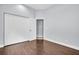 Spacious bedroom featuring hardwood floors, open closet, and soft blue walls at 1424 Ridge Shore Dr, Tarpon Springs, FL 34689
