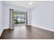 Empty bedroom features tile flooring, natural light, and a patio with sliding glass doors at 1424 Ridge Shore Dr, Tarpon Springs, FL 34689