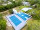 Overhead shot of community basketball and tennis courts well-maintained and ready for play at 1424 Ridge Shore Dr, Tarpon Springs, FL 34689