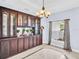 Formal dining room featuring natural light, decorative cabinet, and marble tile flooring at 1424 Ridge Shore Dr, Tarpon Springs, FL 34689