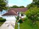 An aerial shot of a charming single-story home with a well-manicured lawn and a two-car garage at 1424 Ridge Shore Dr, Tarpon Springs, FL 34689