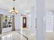 Elegant foyer with marble floors, decorative chandelier, and a charming front door with glass inserts at 1424 Ridge Shore Dr, Tarpon Springs, FL 34689
