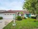 Well maintained single story home with lush landscaping and 2 car garage at 1424 Ridge Shore Dr, Tarpon Springs, FL 34689