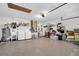 Spacious garage with laundry area, water heater, ample storage, and painted concrete flooring at 1424 Ridge Shore Dr, Tarpon Springs, FL 34689