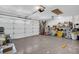 Bright garage featuring an automatic door, overhead storage, and neutral painted concrete flooring at 1424 Ridge Shore Dr, Tarpon Springs, FL 34689