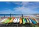 Various colorful kayaks and paddle boards on rack overlooking a calm beach at 1424 Ridge Shore Dr, Tarpon Springs, FL 34689