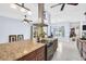 Modern kitchen features stainless steel appliances, granite countertops, and an oversized island cooktop at 1424 Ridge Shore Dr, Tarpon Springs, FL 34689