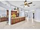 Open-concept kitchen featuring a large island, granite countertops, and dark wood cabinetry at 1424 Ridge Shore Dr, Tarpon Springs, FL 34689