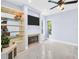 Inviting living room featuring a fireplace, built-in shelving, and natural light at 1424 Ridge Shore Dr, Tarpon Springs, FL 34689