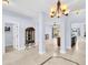 Open-concept living room with columns, chandelier, and views into the kitchen at 1424 Ridge Shore Dr, Tarpon Springs, FL 34689